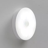Stick-on motion sensor night light installed on stair wall in UK home.